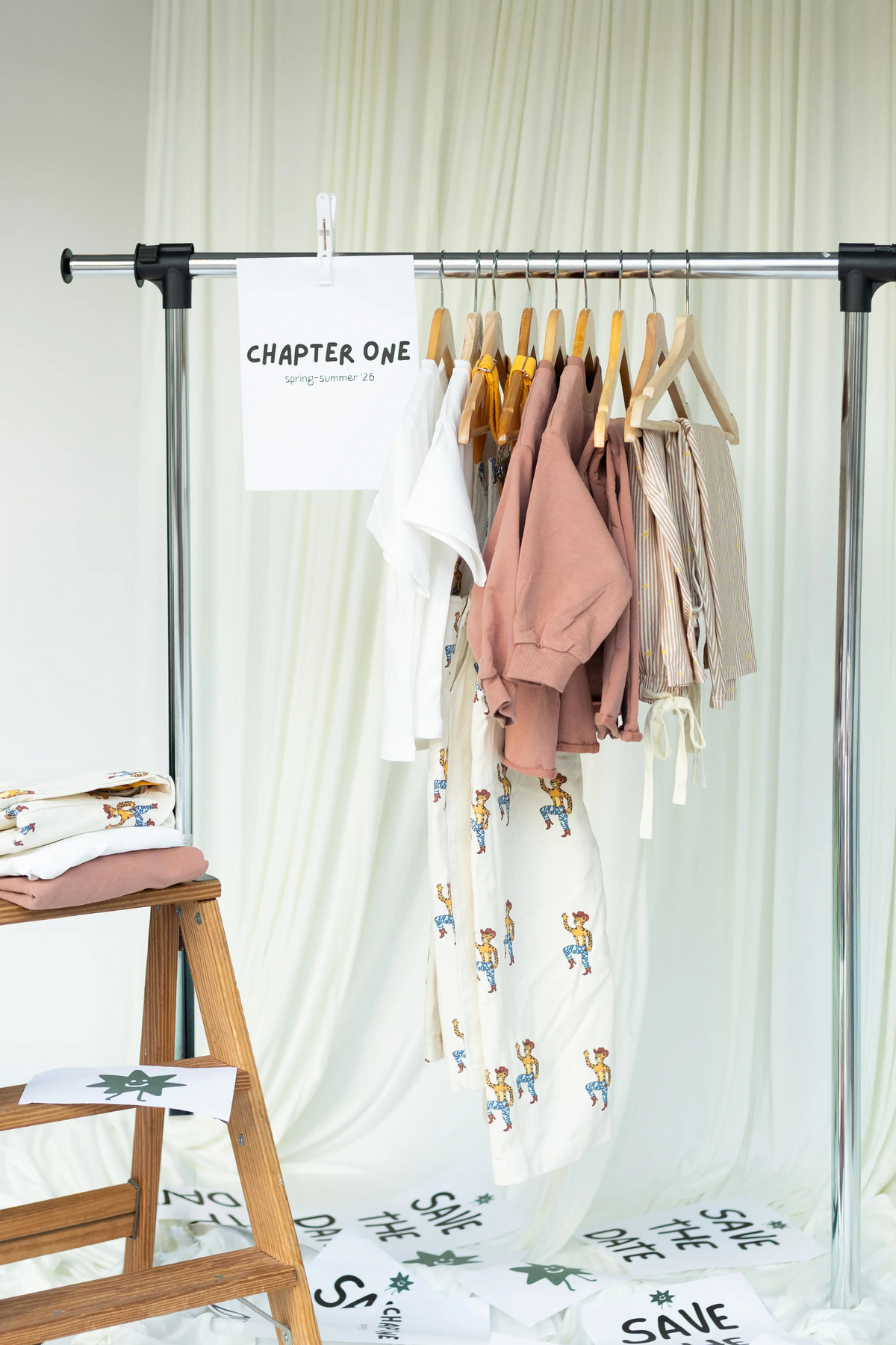 Solettino Kids Originals clothing: Children outdoors wearing premium earthy-toned sweatshirts with sun motifs and designer overalls from the debut collection.