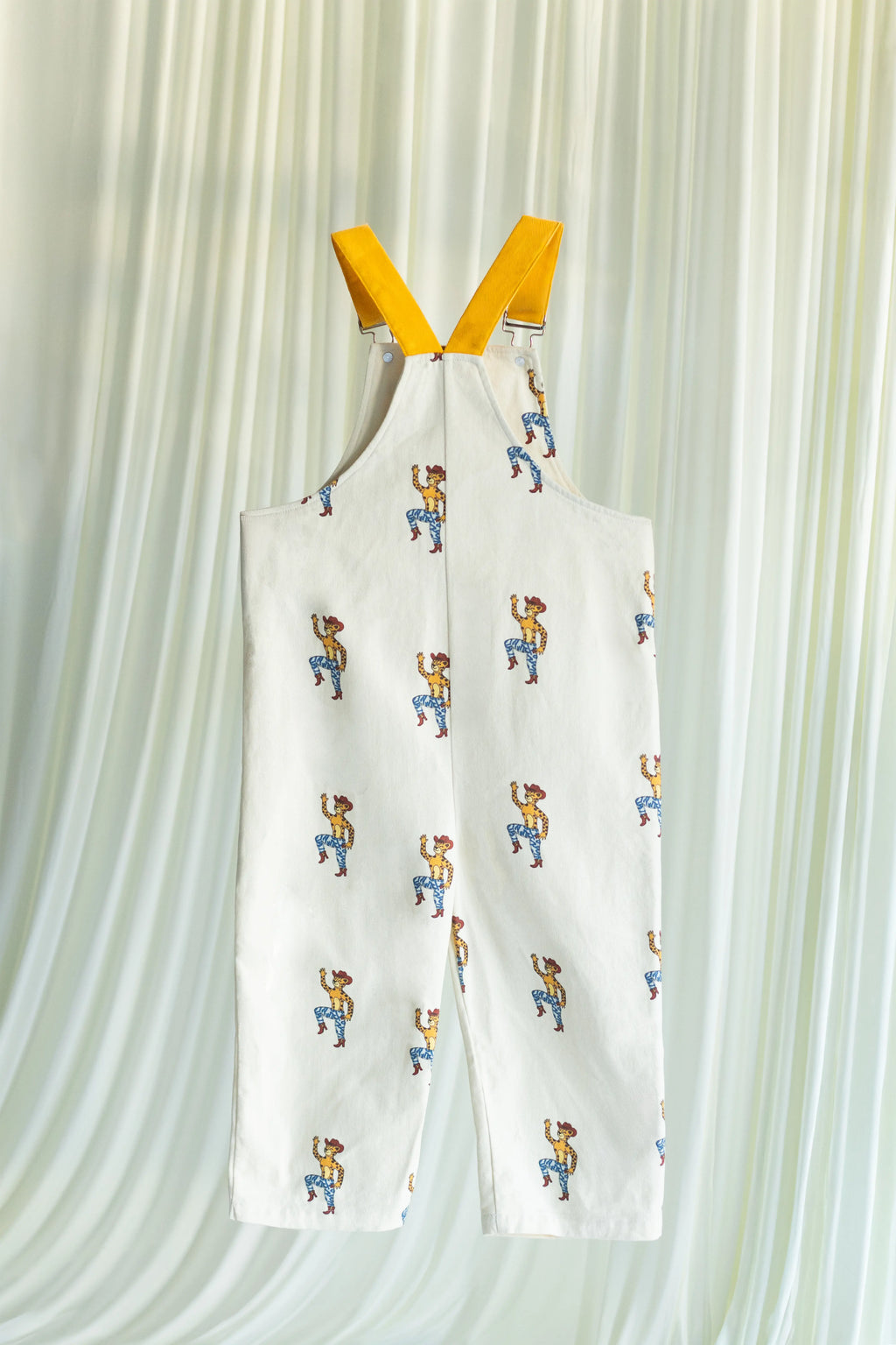 White overall with cartoon pattern on a white background