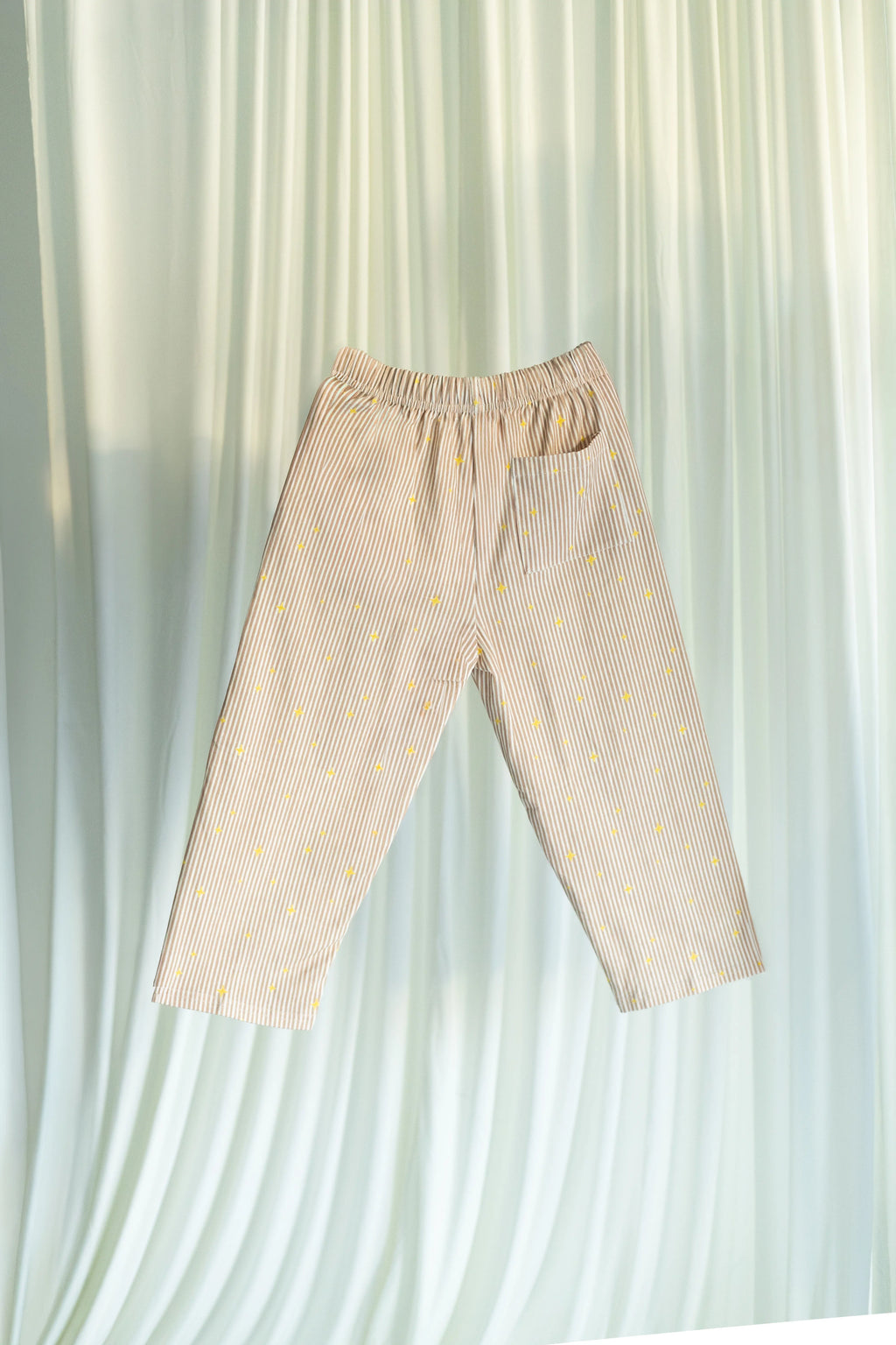 Little Stars Pants on a light white curtain background